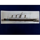 An oversized real photograph postcard, of Titanic about to leave Belfast, in profile with stern