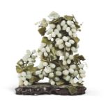 A CHINESE GREEN AND CELADON JADE SCULPTURE DEPICTING GRAPES. MID- 20TH CENTURY