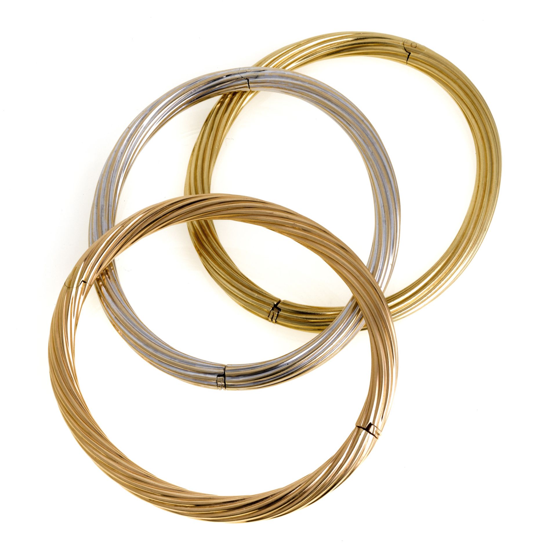 THREE YELLOW WHITE AND RED GOLD BANGLES
