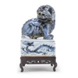 A CHINESE WHITE AND BLUE PORCELAIN GUARDIAN LION LATE 19TH EARLY 20TH CENTURY.