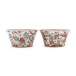 A PAIR OF CHINESE POLYCHROME ENAMELED PORCELAIN CUPS 20TH CENTURY. CHIPS TO ONE CUP.