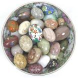 A modern Chinese Canton porcelain bowl, containing a collection of ornaments, mostly egg shaped,
