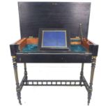 A Victorian ebonised and gilt highlighted lady's writing desk, with lift top revealing a fitted