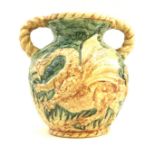 An unusual West German pottery double handled vase, decorated in relief with a dragon on a green