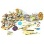 A collection of sewing and needlework items, including several bobbins, crocheting tools, reels of