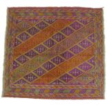 A Gazak rug with purple orange and green ground, diamond patterned field, 126 by 120cm.
