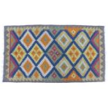 A Maimana Kilim rug with dark blue ground, multi coloured diamond patterned field, white and grey