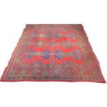 A Turkey carpet with red ground, Maple & Co London, circa 1940, light and dark blue, green and