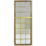 An Edwardian sectional wall mirror, the gilt frame inset with twenty-eight bevelled square mirror