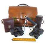 A group of optical instruments, including a pair of black morocco leather bound binoculars, circa