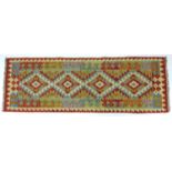 A vegetable dyed wool Choli Kilim runner, with pale green ground and orange edges, four diamond