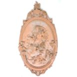 A modern terracotta garden wall plaque, oval form decorated in relief with a classical goddess