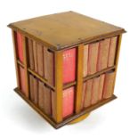 A miniature table top revolving bookcase, containing a set of forty miniature Shakespeare plays,