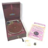 A retro Tonella wind up portable record player, with five gramophone records, two pack of needles,