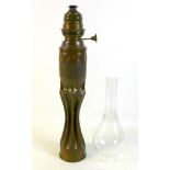 An Art Nouveau/Secessionist trench art oil lamp, of organic, fluted waisted form below planished