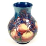 A Moorcroft pottery vase, of baluster form, decorated in Finch and Berry pattern, impressed and