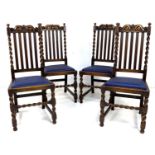 A set of four Edwardian oak dining chairs, with carved crests to the rails, five splat back, and