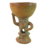 An anthropomorphic pottery drinking vessel, likely pre-Columbian, the stem modelled as a man,