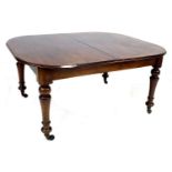 An early Victorian mahogany extending dining table, rectangular surface with rounded corners and