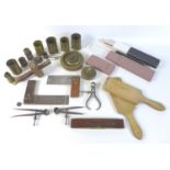 A collection of brass measuring tools including, brass weights, various measuring cups, two