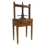 A 19th century elm press, large turned threaded upright with double handle action to square plate,