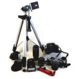 A collection of cameras, lenses, and associated equipment, including a Minolta X-300 camera, a
