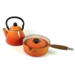 A vintage Le Creuset cast iron saucepan, with pouring lip and wooden handle, a Le Creuset cast