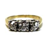 A 14k gold and diamond three stone ring, each stone of approximately 0.33ct, 4mm diameter by 2.66mm,
