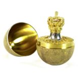 A Stuart Devlin silver gilt 'Surprise' egg, the outer textured surface opening to reveal a crown,