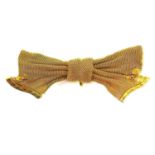 An Edwardian 15ct gold brooch, bow shaped with engraved decoration, pin fastening, 15 by 40mm, 4.9g.