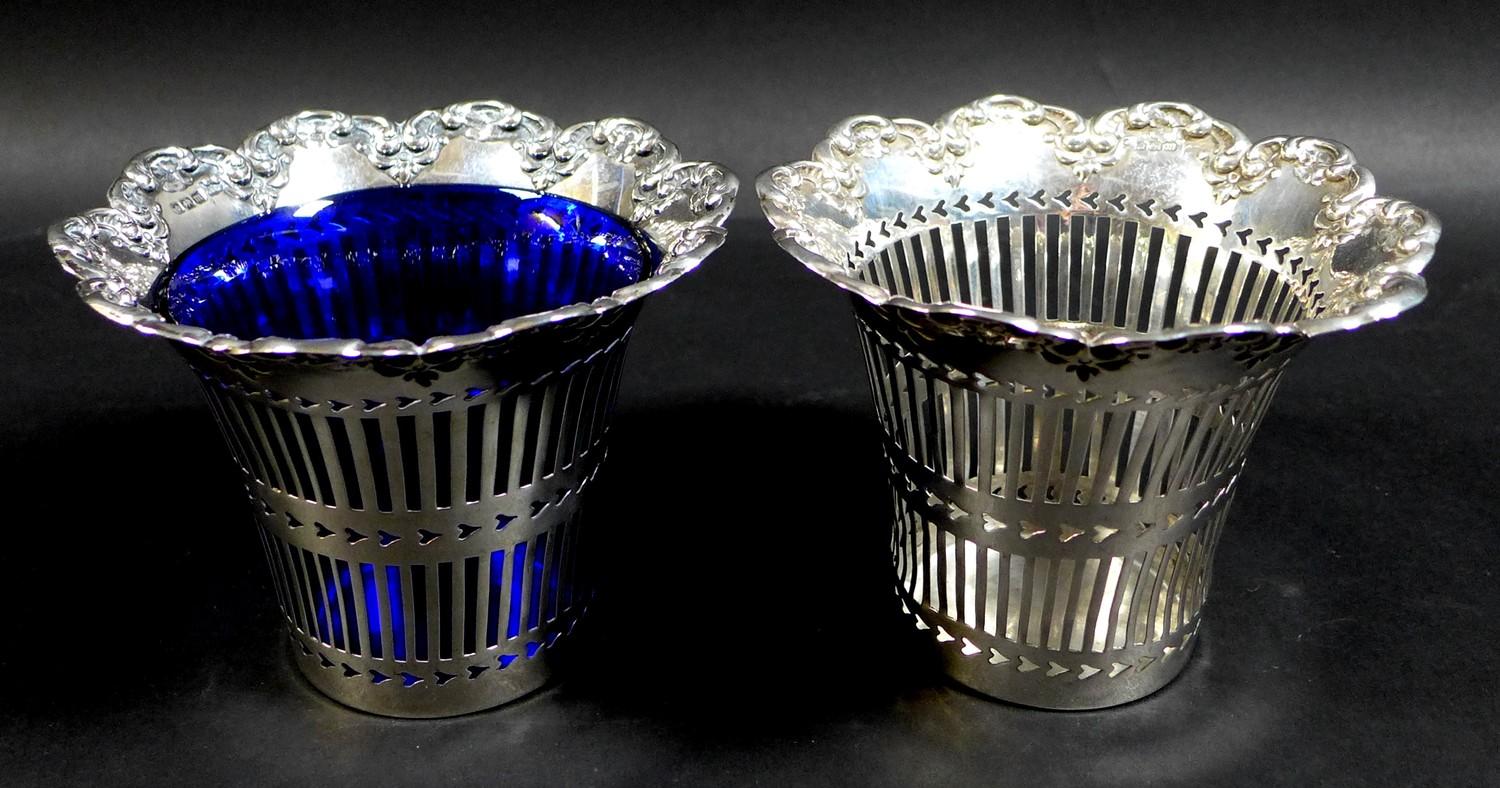 A pair of Edwardian silver baskets, of decagon form with shaped scroll rims and pierced decoration