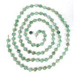 A string of one hundred and seven apple green jade beads, late 19th or early 20th century, a/f