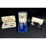 Three George V and later cased silver Christening sets, comprising an egg and cup set, both