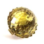 A pineapple cut citrine and yellow metal brooch, the citrine 24mm diameter, 13.2g.