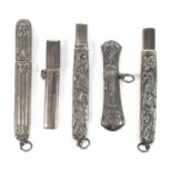 A group of five Edwardian silver pencil holders, four with embossed decoration, one engraved,