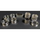 A collection of Edwardian and later silver napkin rings, including three Edwardian rings, two with