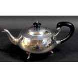 An Arts & Crafts silver teapot, of compressed ovoid form, with all over hammered finish, ebonised