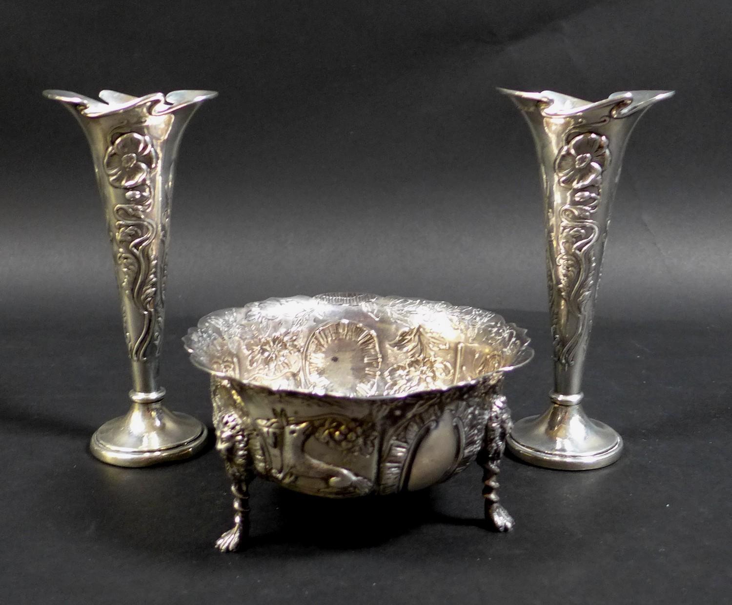 A pair of Edward VII Art Nouveau silver spill vases, with whiplash shaped rims and relief floral