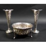 A pair of Edward VII Art Nouveau silver spill vases, with whiplash shaped rims and relief floral