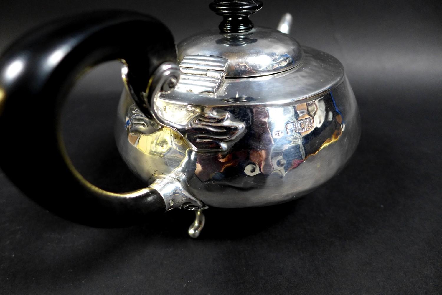 An Arts & Crafts silver teapot, of compressed ovoid form, with all over hammered finish, ebonised - Image 7 of 9