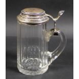 A late 19th century Continental silver mounted cut glass tankard, the stepped circular hinged lid