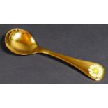 A Georg Jensen gilt Sterling silver 1973 year spoon, with enamel corn marigold to its finial,