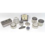 A group of silver topped dressing table items, including glass cosmetics pots, a nail buffer, and