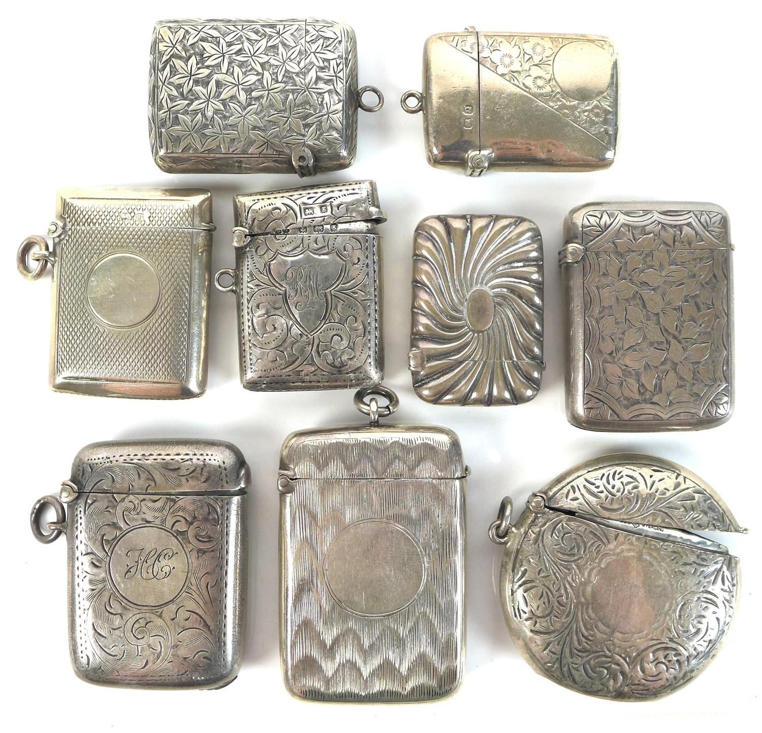 A group of Edwardian silver vesta cases, including a round example with engraved swirling