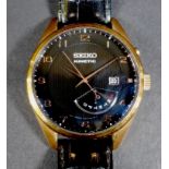 A Seiko Kinetic gentleman's gold plated and stainless steel wristwatch, model 5M84-0AC0, serial