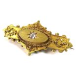 A 19th century 15ct gold gypsy set diamond brooch with safety chain, the single diamond