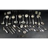 A collection of silver plated items, including various sugar sifter spoons, commemorative spoons,