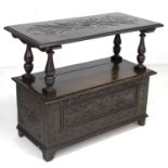 A stained and carved oak monk's bench, mid 20th century, with lifting and sliding top, a/f top and