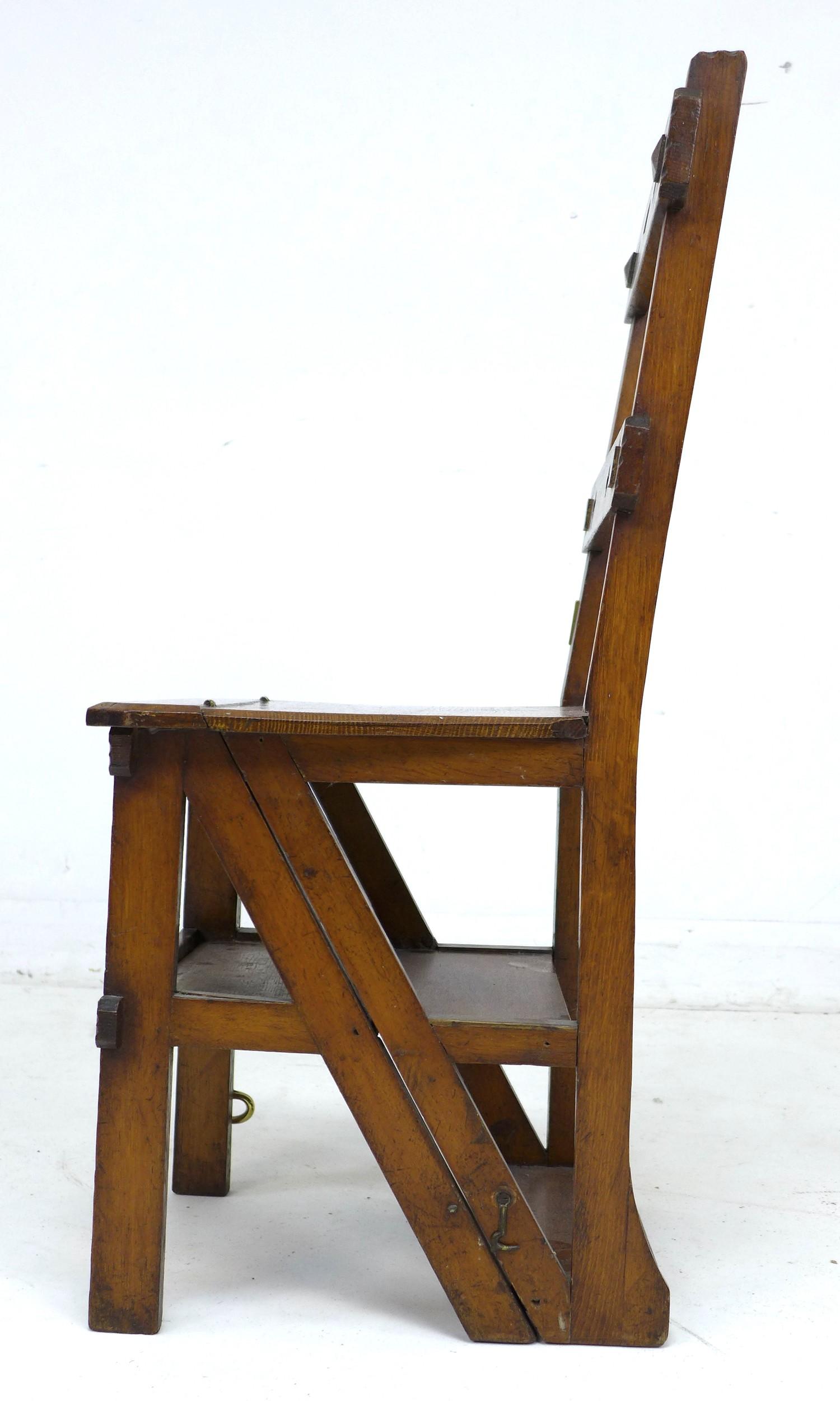 A set of oak metamorphic library steps, folding into a chair, the top rail with pierced quatrefoil - Image 4 of 10