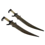 Two Persian knives, with bone inset handles, curved blades, and embossed scabbards, each 42cm